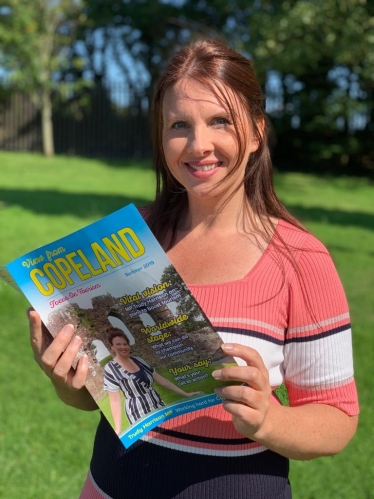 Trudy Harrison Holding Her Tourism Magazine 